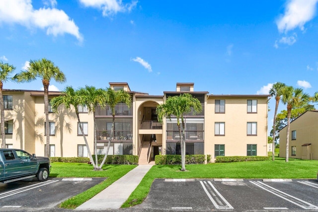 629 Sea Pine Way Unit D1, Greenacres, FL 33415 - view of building exterior featuring uncovered parking
