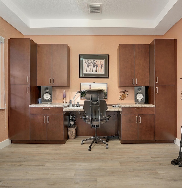 127 Via Castilla, Jupiter, FL 33458 - office featuring built in desk, light wood-type flooring, and a raised ceiling