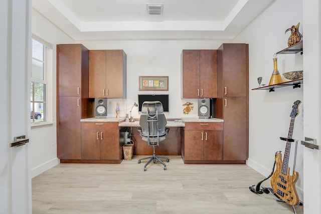 127 Via Castilla, Jupiter, FL 33458 - office area with built in study area, light wood finished floors, and a raised ceiling