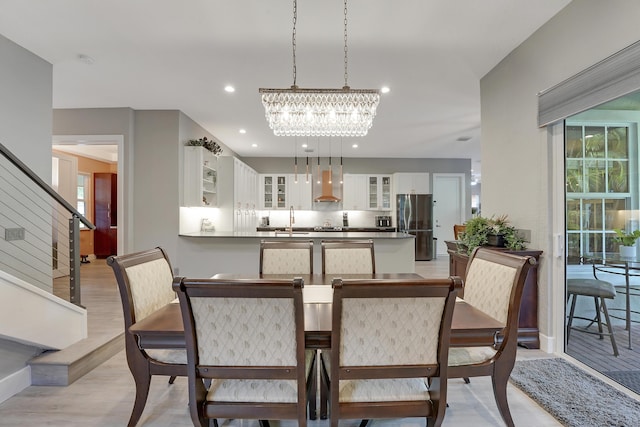 127 Via Castilla, Jupiter, FL 33458 - dining area featuring stairs, a chandelier, light wood finished floors, and recessed lighting