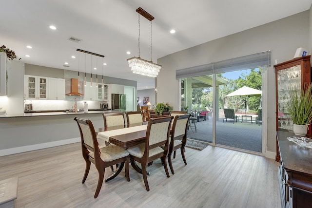 127 Via Castilla, Jupiter, FL 33458 - dining area featuring light wood finished floors, recessed lighting, a chandelier, and baseboards