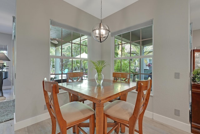 127 Via Castilla, Jupiter, FL 33458 - dining room with baseboards, light wood-style flooring, a ceiling fan, and a chandelier