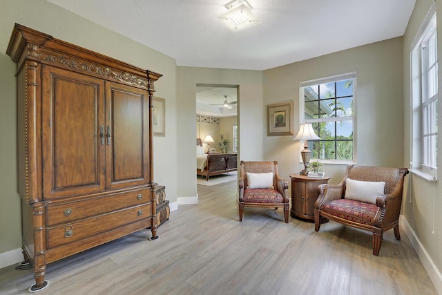 127 Via Castilla, Jupiter, FL 33458 - sitting room featuring light wood-type flooring, baseboards, and a ceiling fan