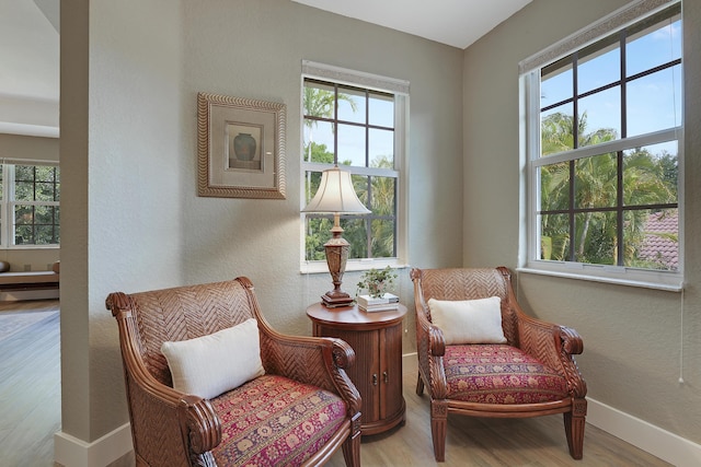 127 Via Castilla, Jupiter, FL 33458 - sitting room with plenty of natural light, wood finished floors, baseboards, and a textured wall