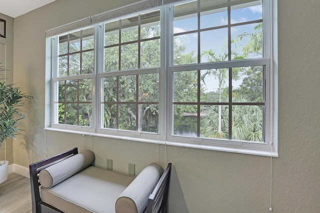 127 Via Castilla, Jupiter, FL 33458 - living area featuring a textured wall, wood finished floors, and baseboards