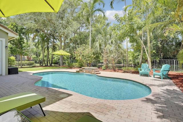 127 Via Castilla, Jupiter, FL 33458 - view of pool featuring a patio, a fenced backyard, a jacuzzi, and view of scattered trees