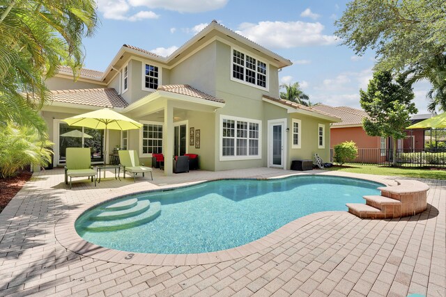 127 Via Castilla, Jupiter, FL 33458 - rear view of house with a patio, a tile roof, and stucco siding