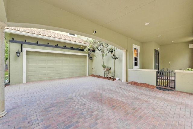 127 Via Castilla, Jupiter, FL 33458 - garage featuring decorative driveway and a gate