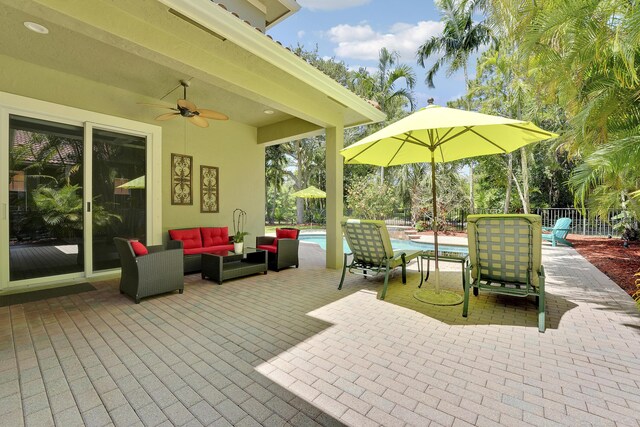 127 Via Castilla, Jupiter, FL 33458 - view of patio with outdoor lounge area, ceiling fan, and an outdoor pool