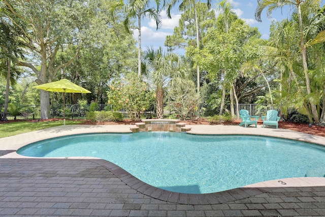 127 Via Castilla, Jupiter, FL 33458 - view of pool with a hot tub, a patio, and view of wooded area