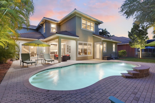 127 Via Castilla, Jupiter, FL 33458 - back of property with a patio area, stucco siding, and a tile roof