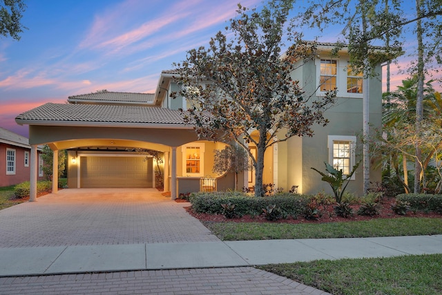 127 Via Castilla, Jupiter, FL 33458 - view of front of home with a garage, driveway, stucco siding, and a tiled roof
