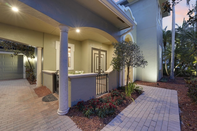 127 Via Castilla, Jupiter, FL 33458 - doorway to property with stucco siding and a garage