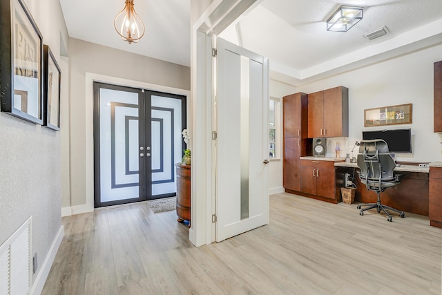127 Via Castilla, Jupiter, FL 33458 - office space featuring light wood-style flooring, built in study area, and french doors