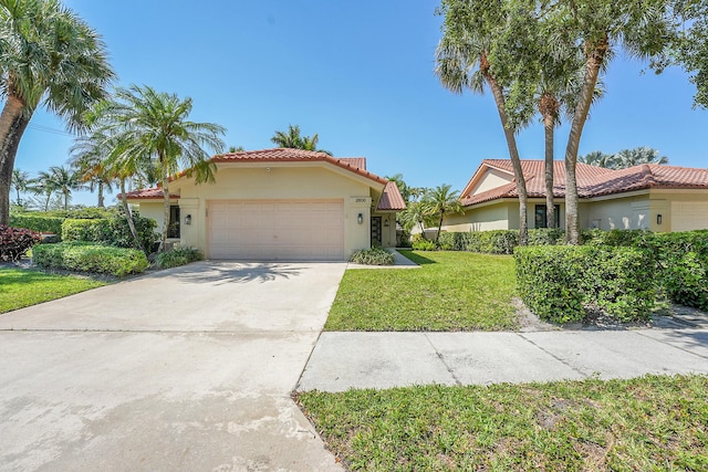 2800 Eagle Ln, West Palm Beach, FL 33409 - mediterranean / spanish home featuring a garage, stucco siding, a front lawn, concrete driveway, and a tiled roof