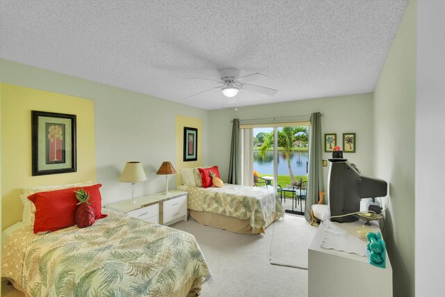 3477 Christopher St Unit 3477, West Palm Beach, FL 33417 - bedroom featuring access to outside, carpet, a water view, a textured ceiling, and ceiling fan