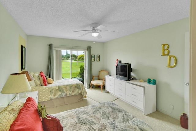 3477 Christopher St Unit 3477, West Palm Beach, FL 33417 - bedroom with access to exterior, light carpet, a ceiling fan, and a textured ceiling