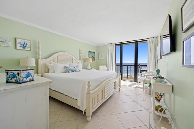 bedroom with access to exterior, light tile patterned floors, crown molding, and expansive windows
