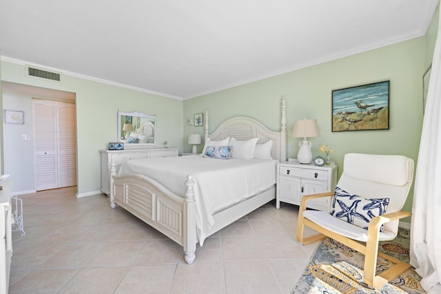 bedroom with crown molding, light tile patterned floors, and baseboards