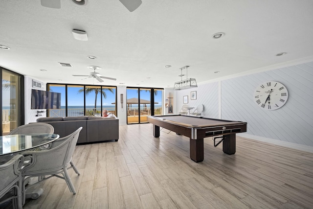 playroom featuring a ceiling fan, a wall of windows, light wood-style floors, billiards, and baseboards