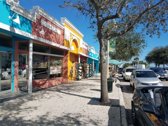 view of asphalt street featuring sidewalks and curbs