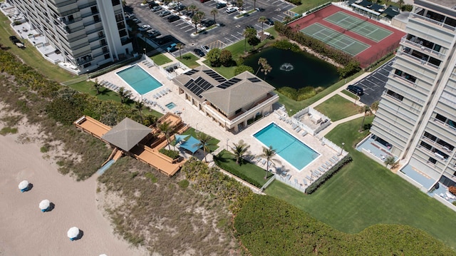 bird's eye view of a pool area and a large body of water