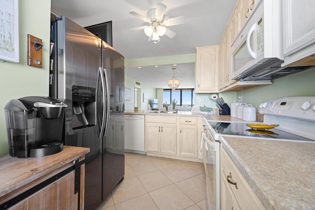 kitchen with white appliances, a ceiling fan, light tile patterned floors, a sink, and pendant lighting