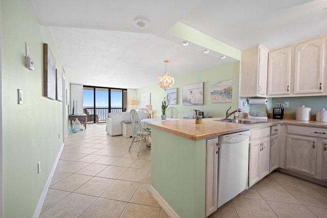 kitchen with dishwasher, light tile patterned floors, a peninsula, a chandelier, and floor to ceiling windows