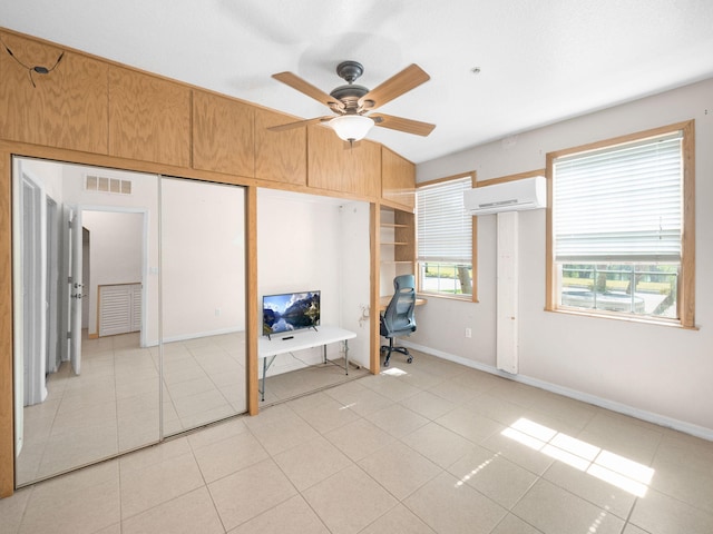 1898 SE Interlachen Dr, Port Saint Lucie, FL 34952 - bedroom with a wall mounted AC, an office area, light tile patterned flooring, baseboards, and a ceiling fan