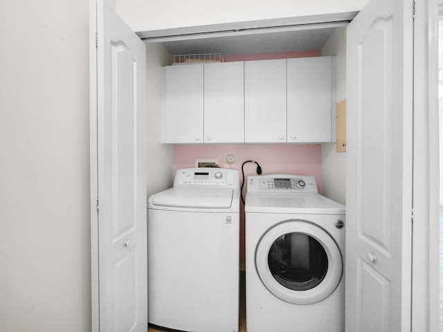 1898 SE Interlachen Dr, Port Saint Lucie, FL 34952 - washroom with washing machine and dryer and cabinet space