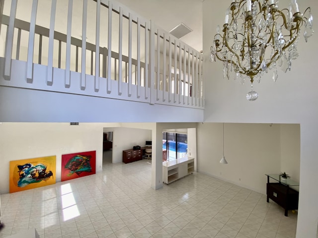 living room featuring a towering ceiling, a chandelier, and tile patterned flooring