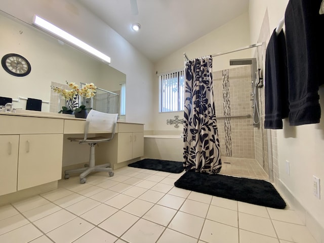 bathroom featuring lofted ceiling, tile patterned floors, tiled shower, a bath, and vanity