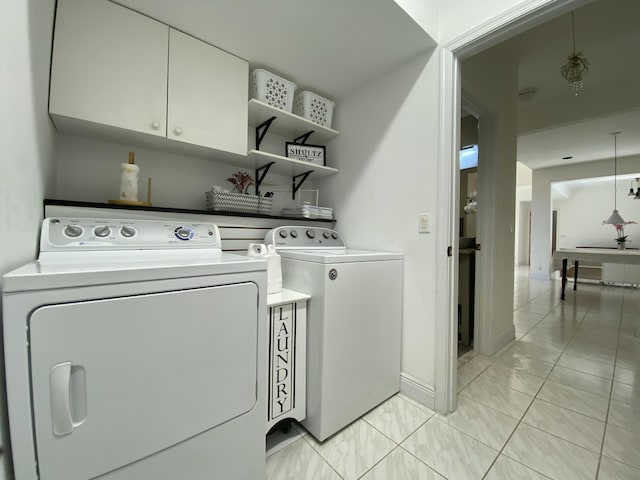 washroom featuring washing machine and dryer and baseboards