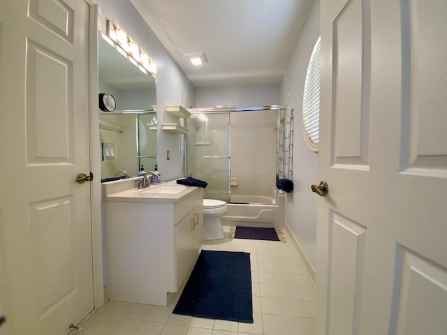 full bath with tile patterned flooring, vanity, baseboards, toilet, and enclosed tub / shower combo