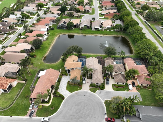 aerial view of property and surrounding area featuring nearby suburban area and a nearby body of water