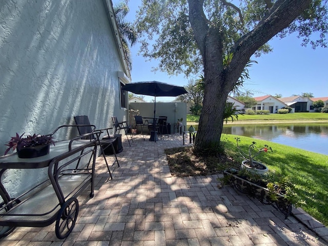 view of patio / terrace with a water view and outdoor dining area