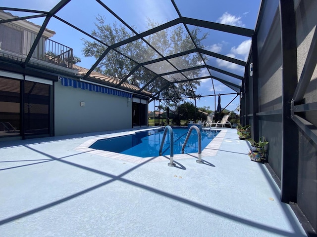outdoor pool featuring a patio area and a lanai