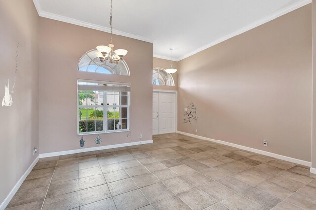 3588 Turtle Island Ct, West Palm Beach, FL 33411 - entrance foyer featuring ornamental molding, a chandelier, baseboards, and light tile patterned floors