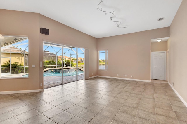 3588 Turtle Island Ct, West Palm Beach, FL 33411 - spare room featuring plenty of natural light, baseboards, and rail lighting