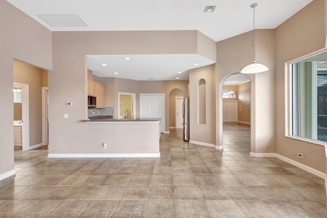 3588 Turtle Island Ct, West Palm Beach, FL 33411 - kitchen featuring appliances with stainless steel finishes, arched walkways, baseboards, a sink, and recessed lighting