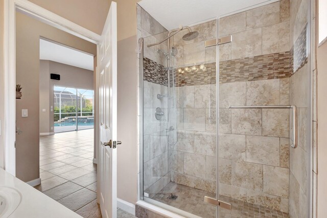 3588 Turtle Island Ct, West Palm Beach, FL 33411 - bathroom with a shower stall, tile patterned floors, and baseboards