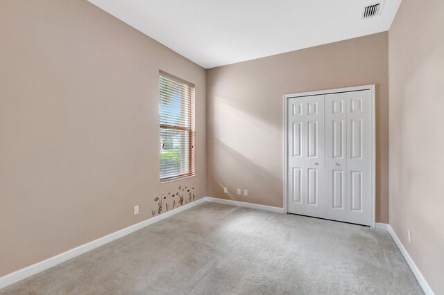 3588 Turtle Island Ct, West Palm Beach, FL 33411 - unfurnished bedroom with light colored carpet, baseboards, and a closet