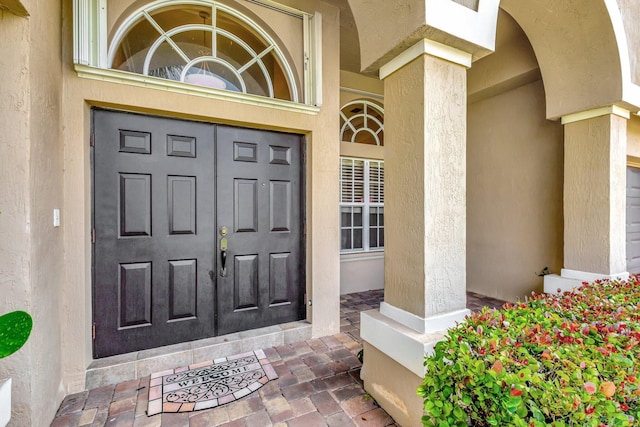 3588 Turtle Island Ct, West Palm Beach, FL 33411 - doorway to property with stucco siding