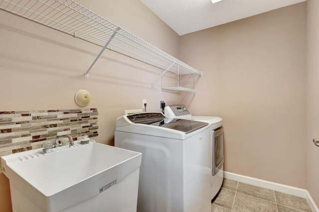 3588 Turtle Island Ct, West Palm Beach, FL 33411 - washroom with baseboards, washing machine and dryer, and light tile patterned floors