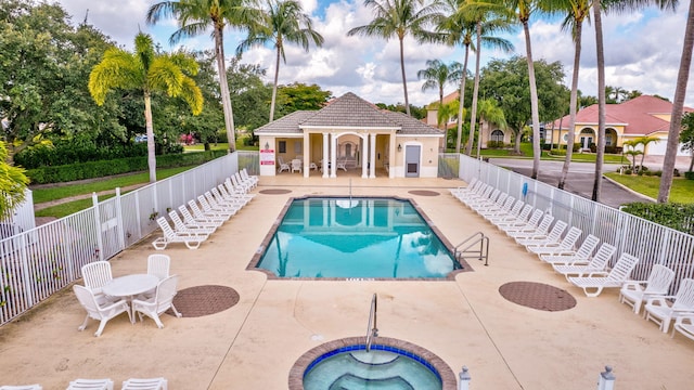 3588 Turtle Island Ct, West Palm Beach, FL 33411 - community pool featuring fence, a patio, a community hot tub, and an outbuilding