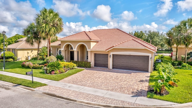 3588 Turtle Island Ct, West Palm Beach, FL 33411 - mediterranean / spanish home featuring stucco siding, a garage, and a front lawn