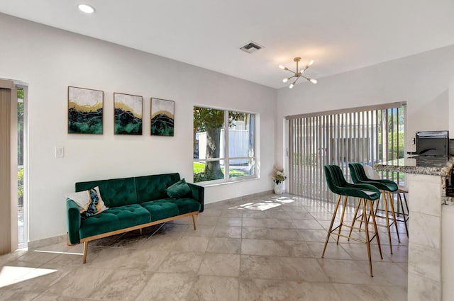 living room with a chandelier, recessed lighting, and baseboards