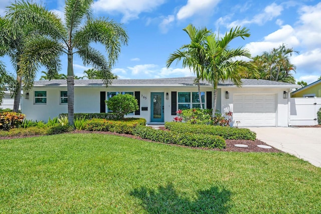 765 Lagoon Dr, North Palm Beach, FL 33408 - ranch-style home with an attached garage, stucco siding, and concrete driveway