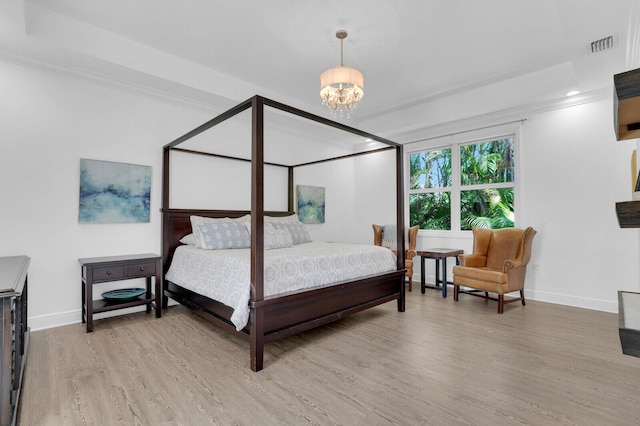765 Lagoon Dr, North Palm Beach, FL 33408 - bedroom with light wood-style floors, baseboards, a chandelier, and ornamental molding