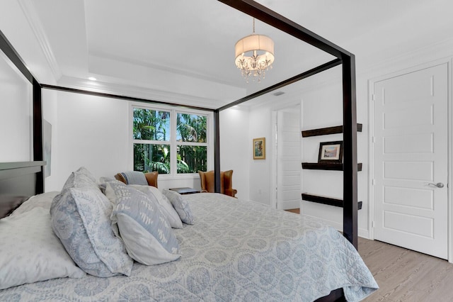 765 Lagoon Dr, North Palm Beach, FL 33408 - bedroom featuring a chandelier, crown molding, and wood finished floors